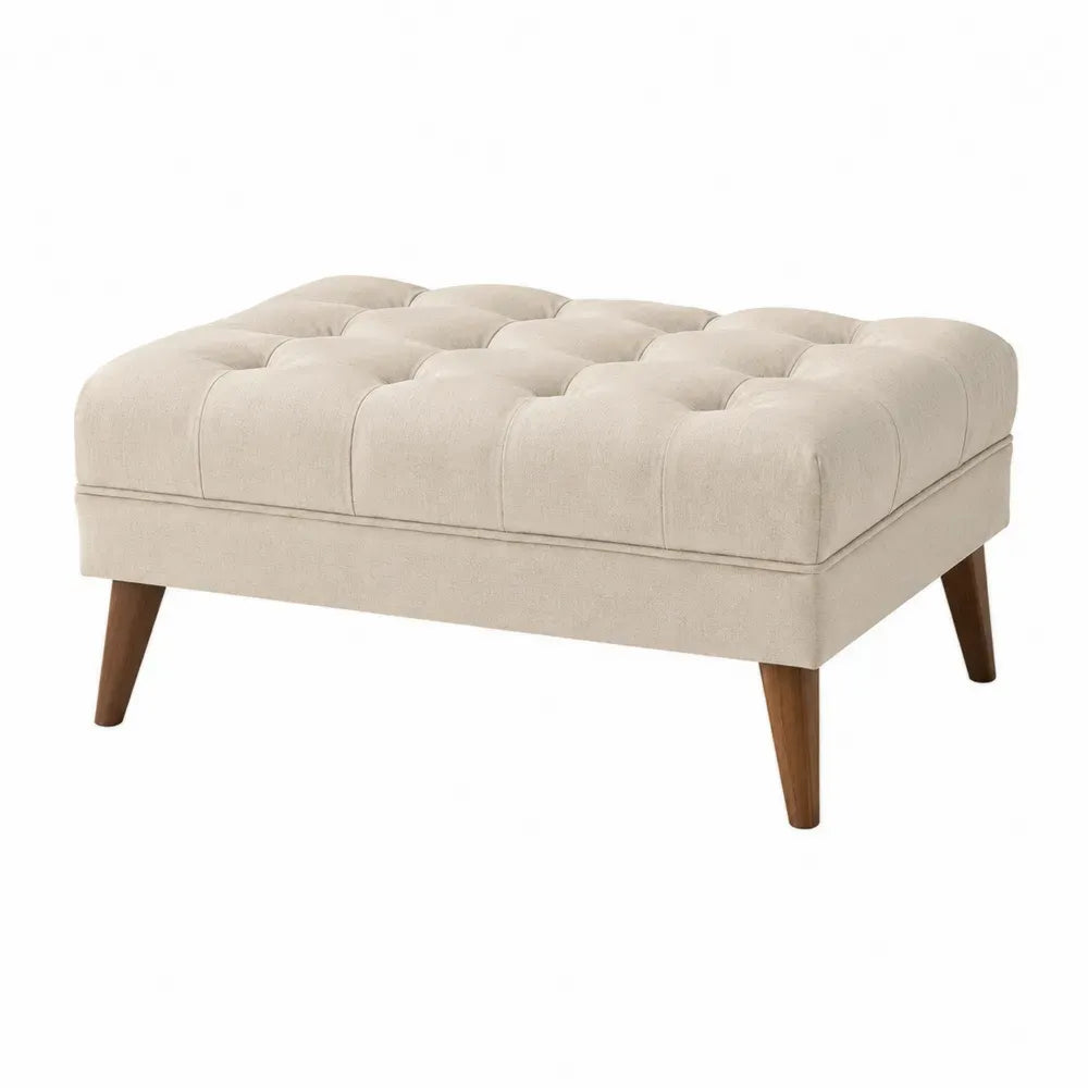 Reposapiés otomano rectangular tapizado en tejido de poliéster beige con capitoné y patas de madera 100 x 70 x 45 cm